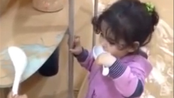 بالفيديو.. أم تطعم اطفالها الرمل